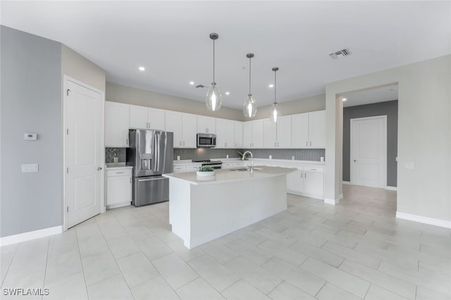 kitchen with light countertops, visible vents, appliances with stainless steel finishes, white cabinets, and a sink