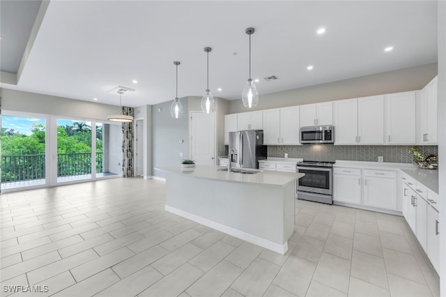 kitchen featuring light countertops, appliances with stainless steel finishes, and decorative backsplash