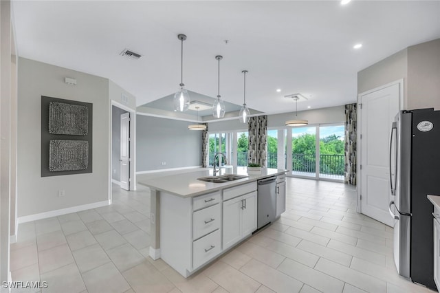 kitchen with visible vents, hanging light fixtures, stainless steel appliances, light countertops, and a sink