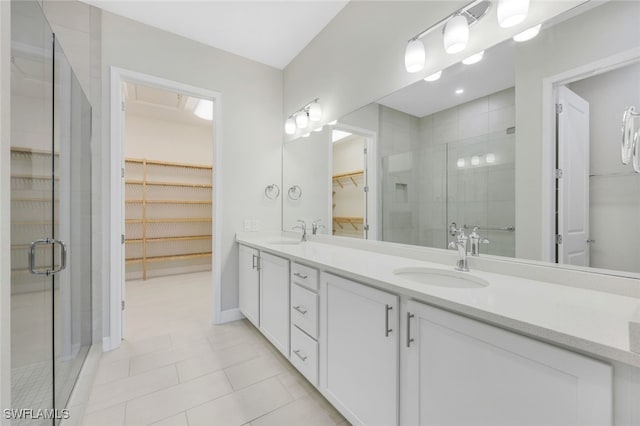 full bathroom with a sink, a shower stall, and double vanity