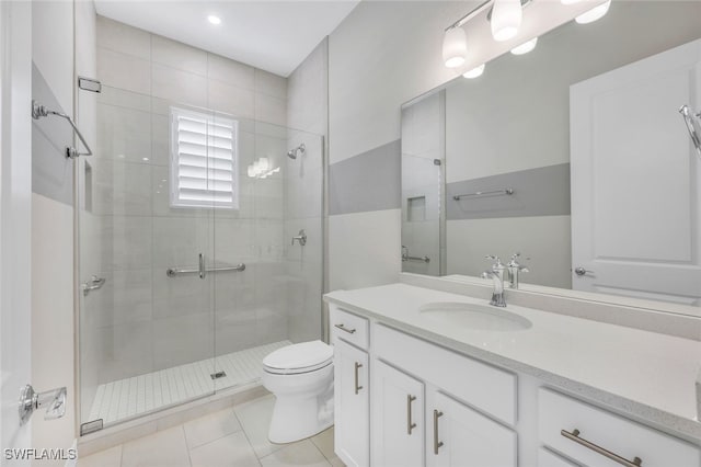 full bathroom featuring a stall shower, tile patterned flooring, vanity, and toilet