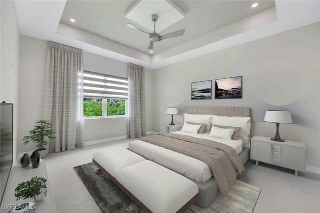 bedroom featuring a ceiling fan, a tray ceiling, baseboards, and light tile patterned floors