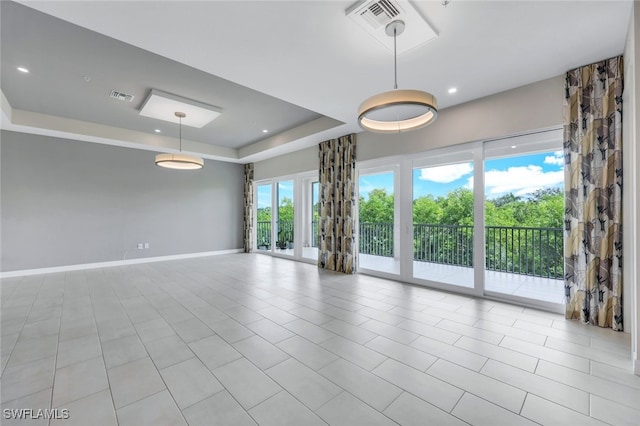 tiled spare room featuring a tray ceiling, recessed lighting, visible vents, and baseboards