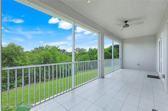 unfurnished sunroom featuring a ceiling fan