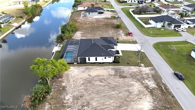 drone / aerial view featuring a residential view and a water view