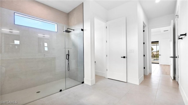 full bathroom featuring baseboards and a stall shower