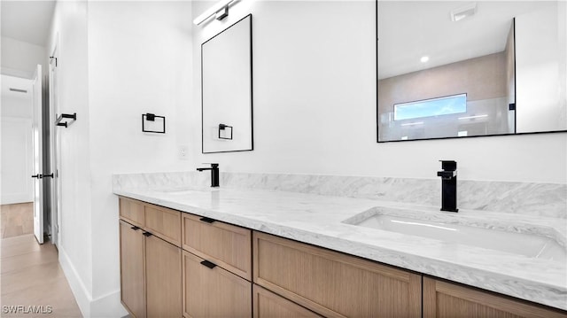 bathroom featuring double vanity and a sink