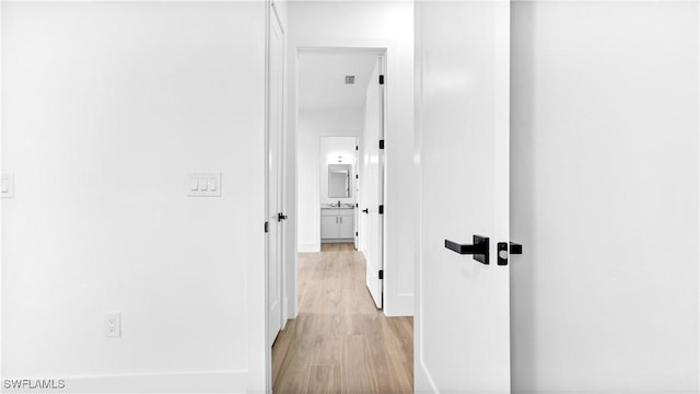 corridor featuring light wood-style flooring