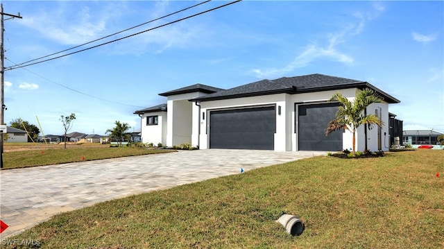 view of front of house with a garage, a front lawn, decorative driveway, and stucco siding