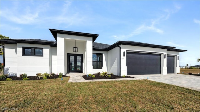 view of front facade featuring french doors, a garage, and a front lawn