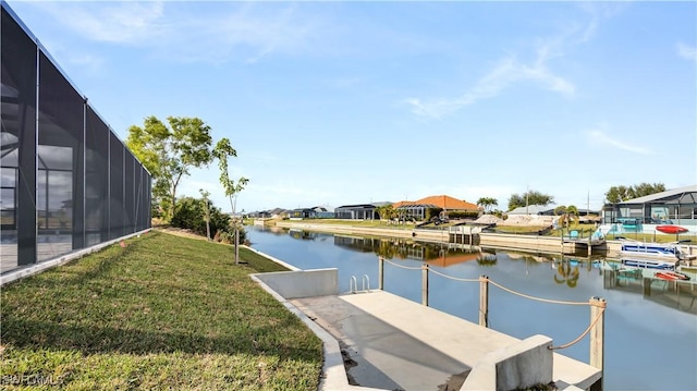 view of dock featuring a yard, a water view, and a lanai