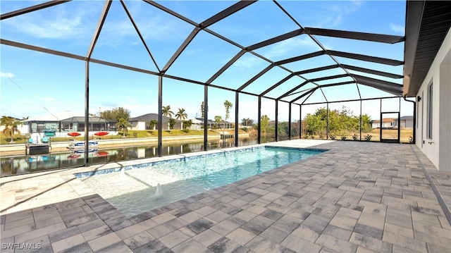 view of swimming pool featuring a water view, a patio area, and a lanai