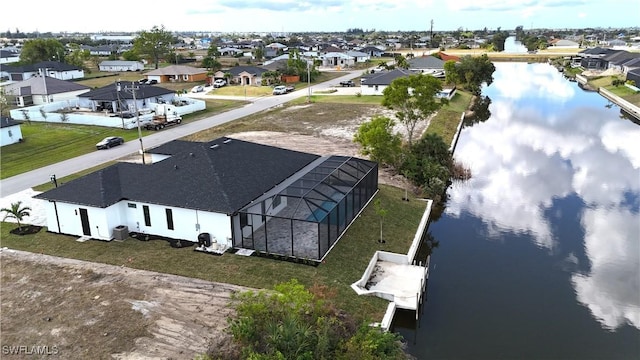 birds eye view of property with a residential view and a water view