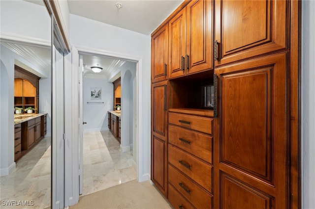 kitchen with light stone countertops and ornamental molding