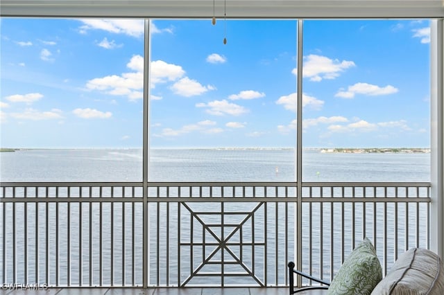 unfurnished sunroom with a water view