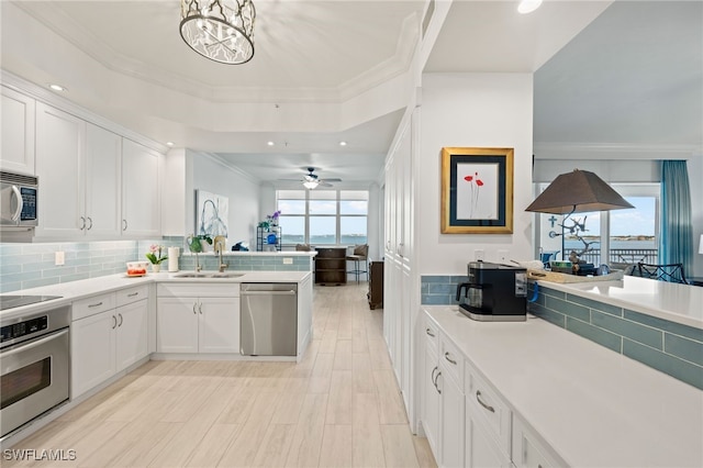 kitchen featuring plenty of natural light, white cabinets, stainless steel appliances, and sink