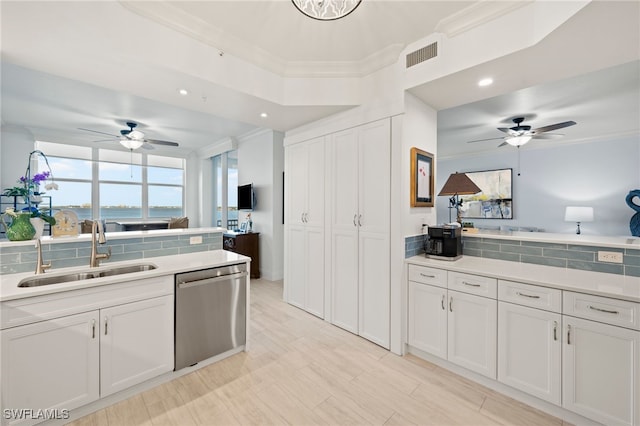 kitchen featuring white cabinets, dishwasher, backsplash, and sink