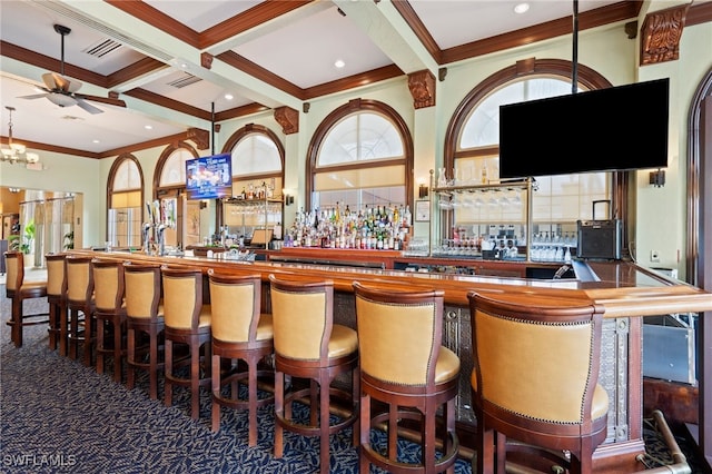 bar featuring carpet, coffered ceiling, ceiling fan, ornamental molding, and beam ceiling