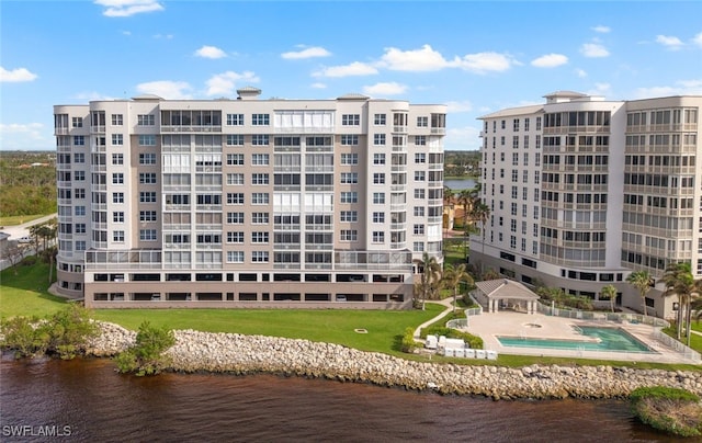 view of property featuring a water view and a community pool