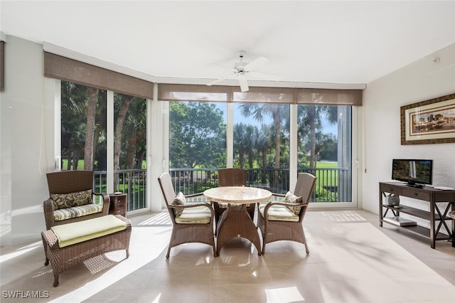 sunroom / solarium featuring ceiling fan