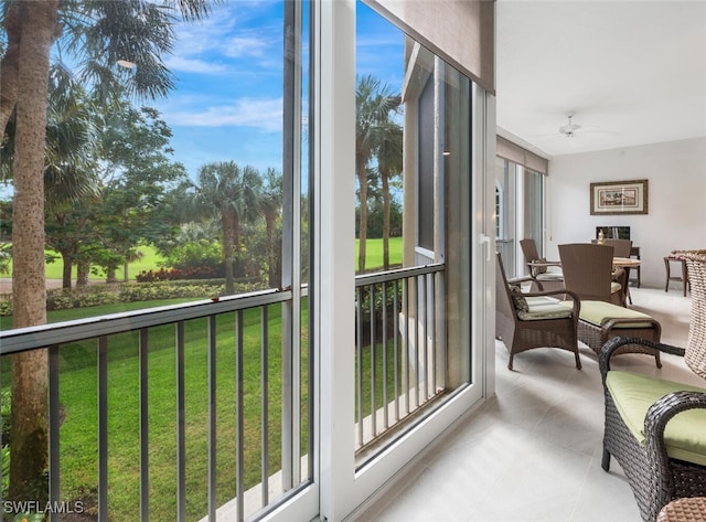 sunroom / solarium featuring plenty of natural light and ceiling fan