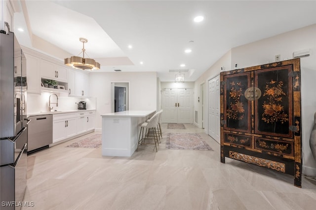 kitchen with dishwasher, a kitchen island, white cabinetry, a sink, and recessed lighting