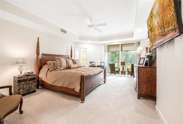 bedroom featuring baseboards, visible vents, light colored carpet, ornamental molding, and a tray ceiling