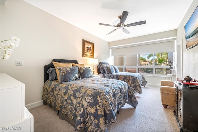 carpeted bedroom with baseboards and a ceiling fan