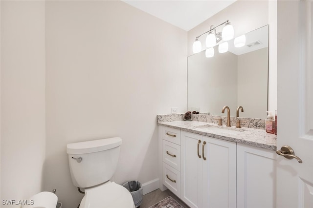 bathroom with visible vents, vanity, and toilet