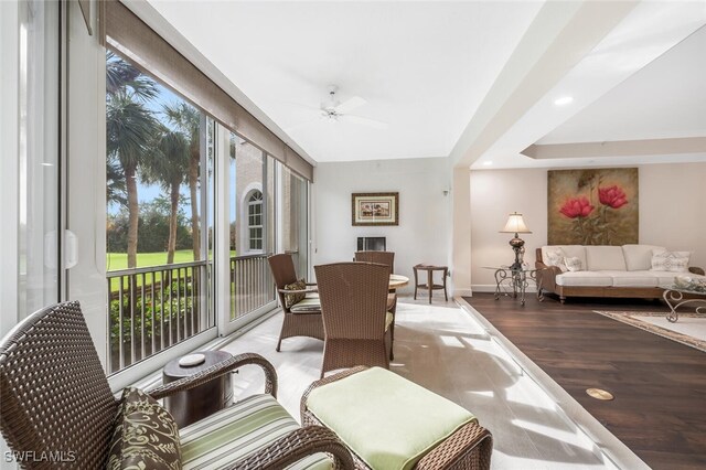 sunroom featuring ceiling fan