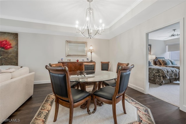 dining room with baseboards, a raised ceiling, and dark wood-type flooring