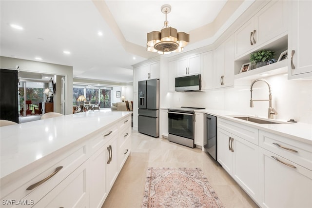 kitchen with open shelves, stainless steel appliances, light countertops, decorative backsplash, and a sink