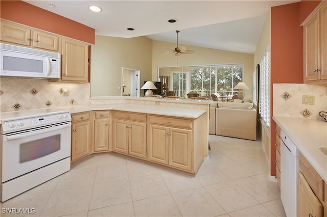 kitchen with lofted ceiling, light brown cabinetry, white appliances, kitchen peninsula, and ceiling fan