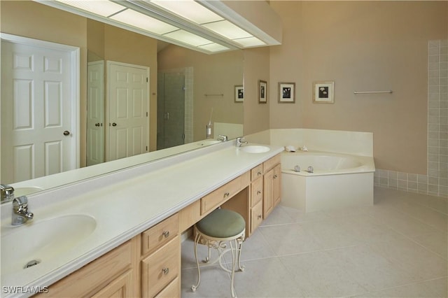 bathroom featuring a bath, double vanity, a sink, and tile patterned floors