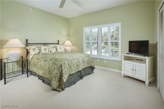 carpeted bedroom featuring ceiling fan, baseboards, and a closet