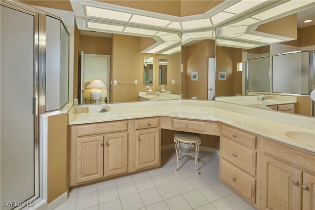 bathroom with vanity, tile patterned flooring, and a shower with door