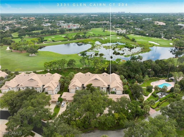 aerial view featuring a water view, view of golf course, and a residential view