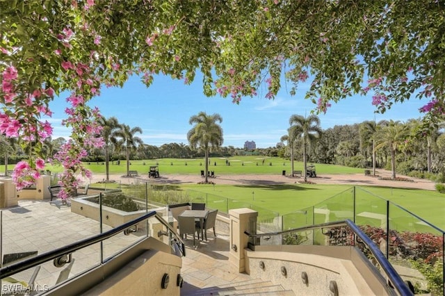 surrounding community with a patio and golf course view