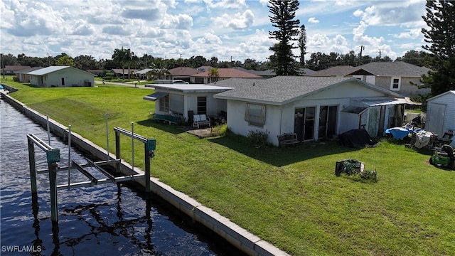 rear view of property featuring a yard and a water view