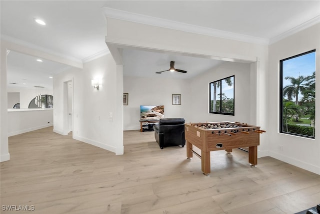 playroom with light hardwood / wood-style floors, crown molding, and ceiling fan