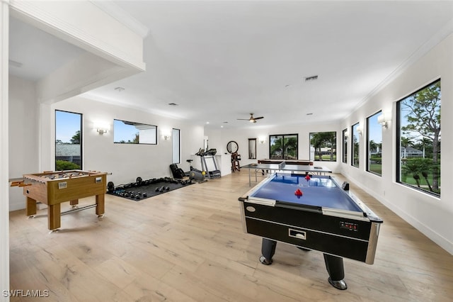 recreation room with light hardwood / wood-style floors, ornamental molding, and ceiling fan