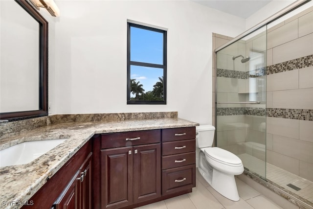 bathroom featuring vanity, tile patterned flooring, toilet, and a shower with shower door