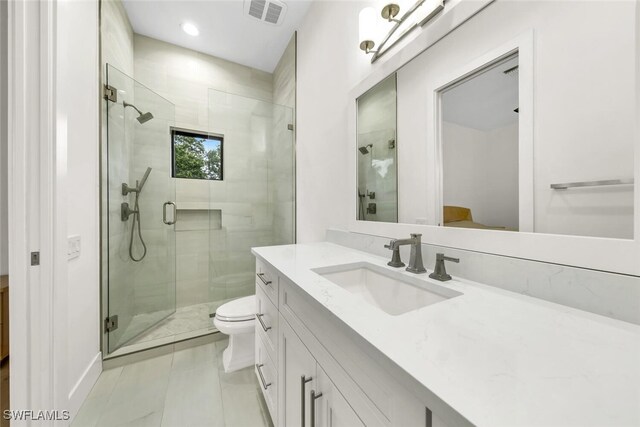 bathroom featuring vanity, toilet, and walk in shower