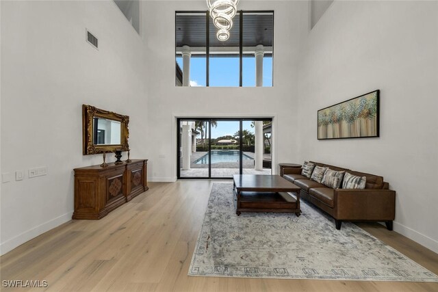 living room with hardwood / wood-style flooring and a high ceiling