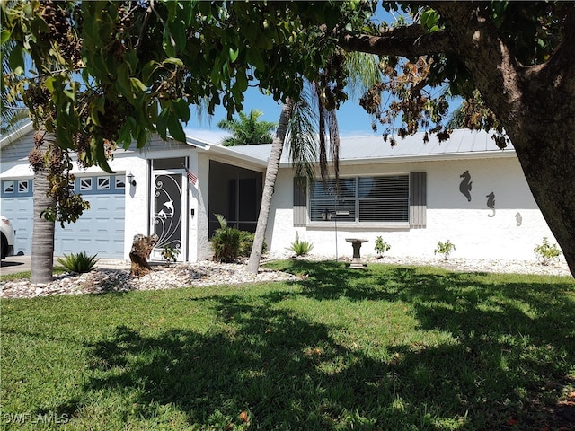 single story home with a garage and a front yard