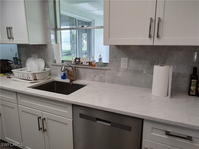 kitchen featuring dishwasher, white cabinetry, and sink