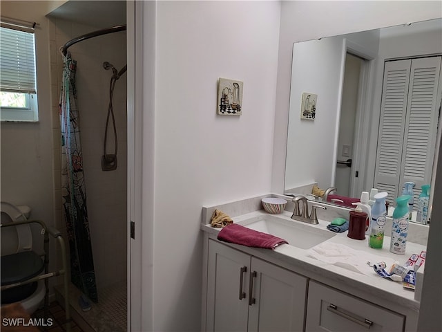 bathroom with vanity, toilet, and curtained shower