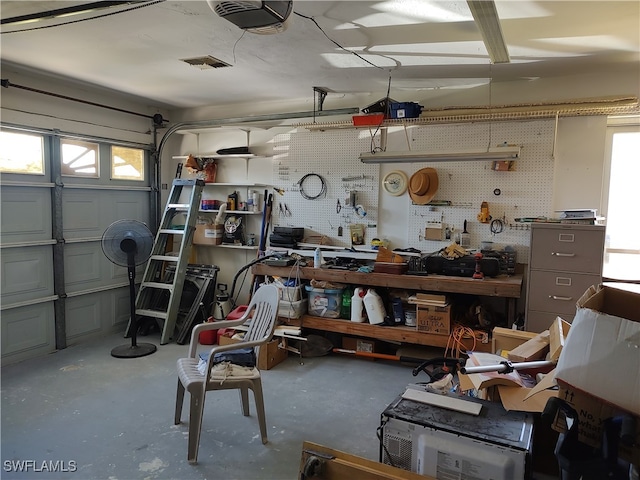 garage featuring a garage door opener and a workshop area