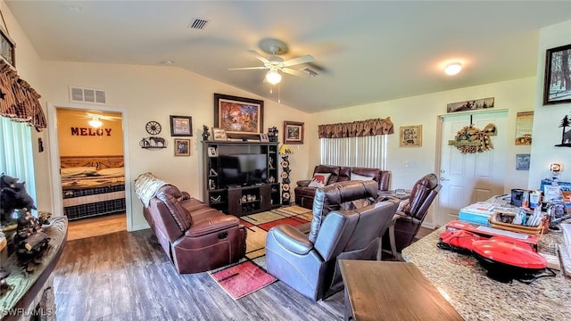 living room with ceiling fan, hardwood / wood-style flooring, and vaulted ceiling