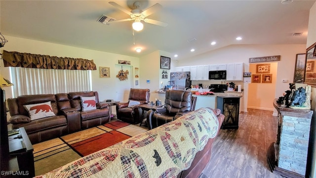 living room with ceiling fan, hardwood / wood-style flooring, and lofted ceiling